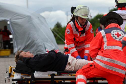 epa12947897 Members of the Bavarian Red Cross and a role player participate in an exercise demonstrating the organization’s complex emergency response system in Munich, Germany, 11 May 2026. The drill involved more than 75 emergency responders and role players and simulated a mass casualty incident caused by a crowd accident and the leak of an initially...