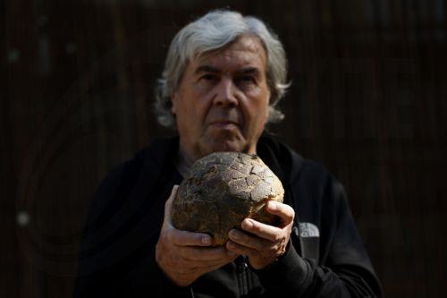 epa12952283 Geologist Alain Cabot poses with a dinosaur egg at the Dinosaur Museum-Park in Meze, southern France, 12 May 2026 (issued 13 May 2026). Founder of the park, Alain Cabot, has discovered dozens of fossilised eggs in French territory. The discovery of about 100 dinosaur eggs dating back approximately 72 million years makes this deposit one of the...