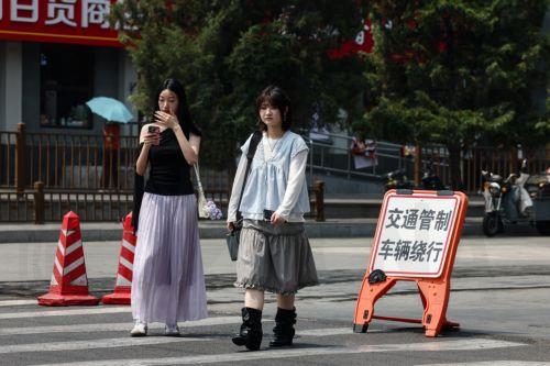 epa12952333 People pass by the entrance of the Temple of Heaven in Beijing, China, 13 May 2026. US President Donald Trump is scheduled to pay a state visit to China from 13 to 15 May.  EPA/WU HAO