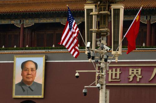 epa12952931 US (L) and Chinese flags flutter next to a portrait of Chinese communist leader and founder of the People's Republic of China Mao Zedong at Tiananmen Square, in Beijing, China, 13 May 2026. US President Donald Trump is due to arrive in Beijing for a high-stakes state visit running through 15 May, marking his first return to the mainland since...