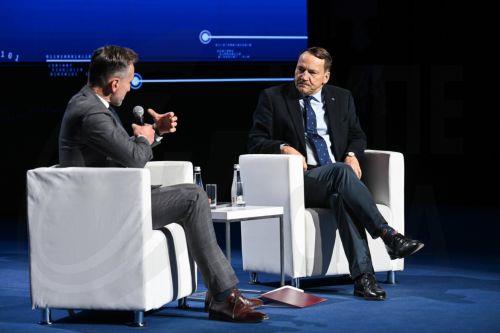 epa12952944 Polish Deputy Prime Minister, Minister of Foreign Affairs Radoslaw Sikorski (R) and journalist Piotr Krasko (L) at the inaugural conversation 'Europe on a strategic course - security, sovereignty and the future of economic cooperation' during the opening of the 12th International Maritime Congress at the Polish Theatre in Szczecin, north-western...