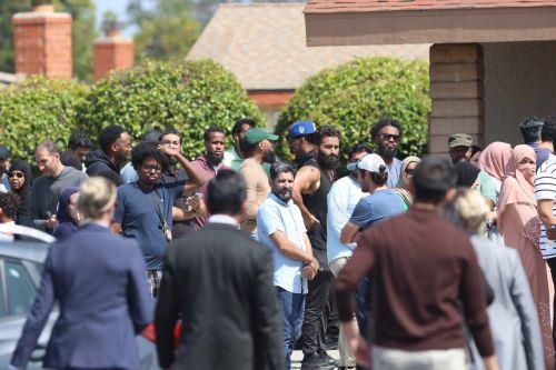 epa12972647 Members of the Islamic Community watch as San Diego's Mayor Todd Gloria (bottom C) walks toward them as they await news of the mosque shooting in San Diego, California, USA, 18 May 2026.  Police agencies from across San Diego County responded to an active shooter incident at the Islamic Center of San Diego in the Clairemont neighborhood. Three...