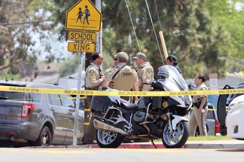 epa12972654 Law enforcement personnel gather on the scene to respond to an active shooting incident at the Islamic Center of San Diego, located in the Clairemont neighborhood in San Diego, California, USA, 18 May 2026.  Police agencies from across San Diego County responded to an active shooter incident at the Islamic Center of San Diego in the Clairemont...