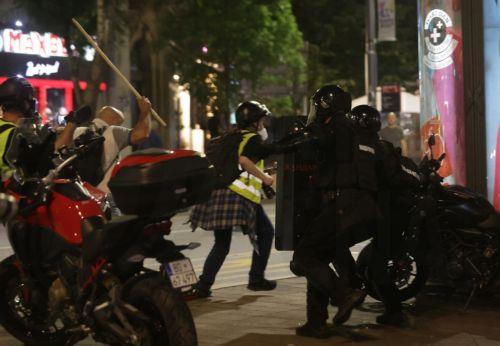 epa12988426 A protester takes a swing at riot police officers after a mass student-led anti-government rally in Belgrade, Serbia, 23 May 2026. Thousands gathered to ramp up pressure on the government and demand early parliamentary elections. The political movement originally erupted across the country following the November 2024 canopy collapse at the Novi...