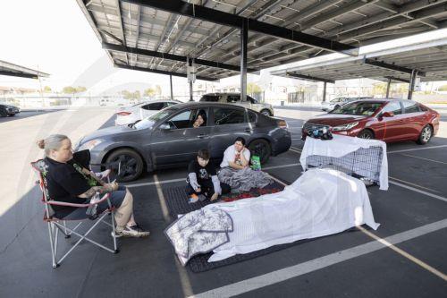 epa12989306 Family members from Anaheim, Andrea Luna, Jules Olivas, Joshua Olivas, and Jessica Castro and their 8 cats are sheltering in their cars at JFK High School evacuation center after evacuating their home due to a chemical leak from a large storage tank at the GKN Aerospace facility; in Garden Grove, California USA, 23 May 2026. A failing...