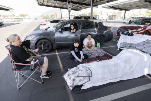epa12989308 Family members from Anaheim, Andrea Luna, Jules Olivas, Joshua Olivas, and Jessica Castro and their 8 cats are sheltering in their cars at JFK High School evacuation center after evacuating their home due to a chemical leak from a large storage tank at the GKN Aerospace facility; in Garden Grove, California USA, 23 May 2026. A failing...
