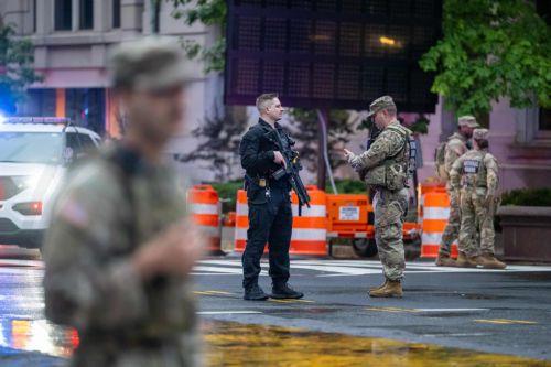 epaselect epa12989275 Members of the National Guard stand at a perimeter near the White House complex following reports of gunfire near 17th Street and Pennsylvania Avenue NW in Washington, DC, USA, 23 May 2026. The agency confirmed via social media that it was working with personnel on the ground to corroborate reports of shots fired.  EPA/Matt Kaminsky