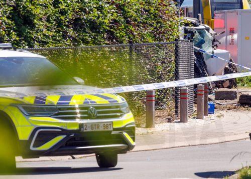 epa12994699 A police vehicle parked at the scene of a collision between a train and a school minibus at a railroad crossing in Buggenhout, Belgium, 26 May 2026. According to statements from Belgian Mobility Minister Jean-Luc Crucke and local authorities, four people, including two children, were confirmed dead and several others seriously injured following...