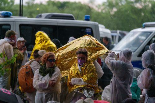 epa13003741 Protesters protect themselves from rain and thunder at a Uniper power plant in Gelsenkirchen, Germany, 29 May 2026. Members of the organization 'Ende Gelaende' entered the plant's grounds during a protest action, leading to a blockade of the facility.  EPA/CHRISTOPH RUTENKOLK