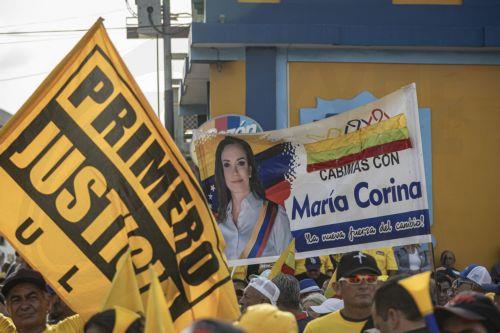 epa13006056 People hold a sign bearing the image of opposition leader and Nobel Peace Prize laureate Maria Corina Machado at a demonstration in Maracaibo, Venezuela, 30 May 2026. More than a thousand Venezuelans, along with several of the country’s leading opposition figures, gathered in Maracaibo, the capital of Zulia state to demand the holding of...