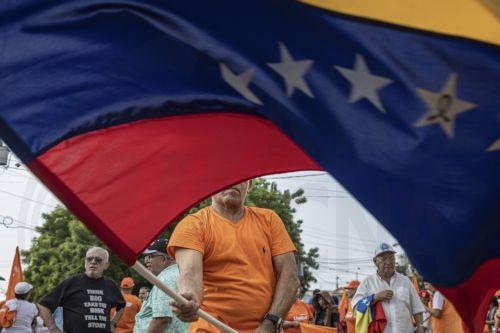 epa13006059 A person waves a Venezuelan flag at a demonstration in Maracaibo, Venezuela, 30 May 2026. More than a thousand Venezuelans, along with several of the country’s leading opposition figures, gathered in Maracaibo, the capital of Zulia state to demand the holding of presidential elections and the release of all political prisoners.  EPA/Henry...