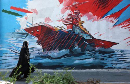 epa13012533 An Iranian woman walks next to an anti-US and Israeli mural in Tehran, Iran, 03 June 2026. Iran and the US traded strikes despite a ceasefire as the conflict involving Iran, the US, and Israel continues. According to US Central Command (CENTCOM), US forces intercepted multiple Iranian ballistic missiles and drones and conducted self-defense...