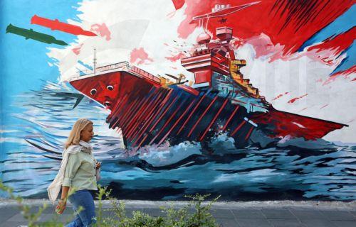 epa13012536 An Iranian woman walks next to an anti-US and Israeli mural in Tehran, Iran, 03 June 2026. Iran and the US traded strikes despite a ceasefire as the conflict involving Iran, the US, and Israel continues. According to US Central Command (CENTCOM), US forces intercepted multiple Iranian ballistic missiles and drones and conducted self-defense...
