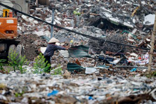 epa13017067 A woman collects garbage at a demolition site in Hanoi, Vietnam, 05 June 2026. World Environment Day is celebrated globally every year on 05 June and aims to bring awareness to environmental issues. The theme for 2026 is ‘Inspired by Nature. For Climate. For Our Future’.  EPA/LUONG THAI LINH