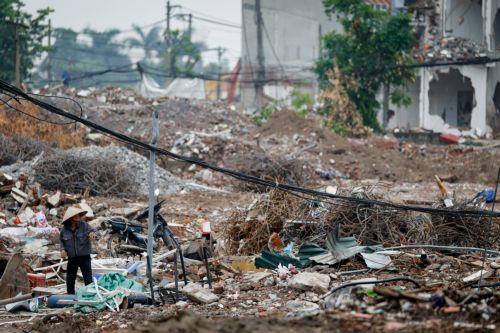 epa13017068 A woman collects garbage at a demolition site in Hanoi, Vietnam, 05 June 2026. World Environment Day is celebrated globally every year on 05 June and aims to bring awareness to environmental issues. The theme for 2026 is ‘Inspired by Nature. For Climate. For Our Future’.  EPA/LUONG THAI LINH