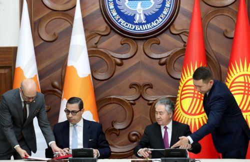 epa13024033 Cypriot Foreign Minister Constantinos Kombos (C-L) and Kyrgyz Foreign Minister Jeenbek Kulubayev (C-R) sign documents during a meeting in Bishkek, Kyrgyzstan, 08 June 2026. Kombos is on an official visit to Bishkek.  EPA/IGOR KOVALENKO
