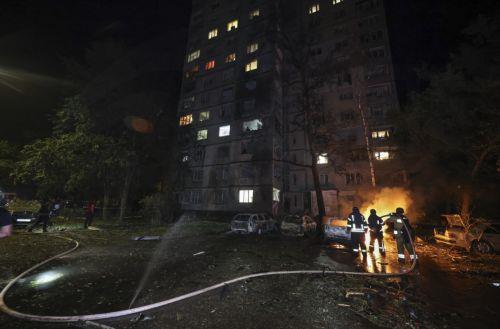 epa13025584 Ukrainian rescuers work at the site of a Russian strike on a residential area in Kharkiv, Ukraine, 09 June 2026, amid the ongoing Russian invasion. At least three people were killed and 18 injured, including two children, as Russia attacked Kharkiv and the region, according to the State Emergency Service.  EPA/SERGEY KOZLOV