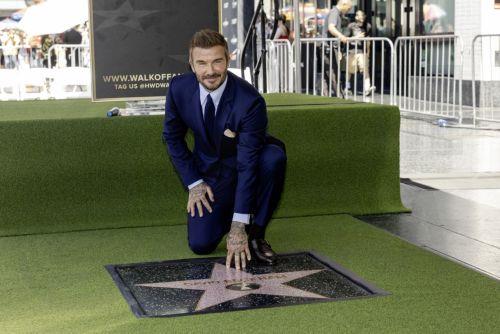 epa13033485 British former soccer player David Beckham (C) poses next to his star during a ceremony honoring him on the Hollywood Walk of Fame in Los Angeles, California, USA, 12 June 2026. Beckham was recognized in the Sports Entertainment category.  EPA/TED SOQUI
