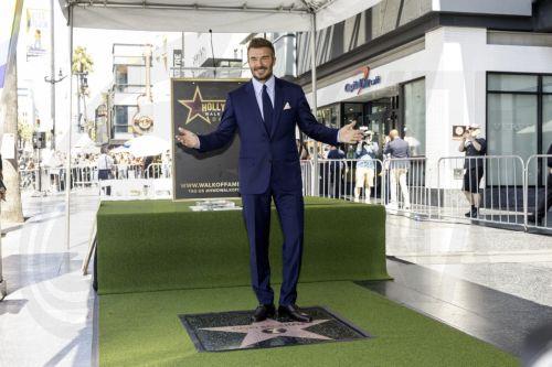 epa13033488 British former soccer player David Beckham poses next to his star during a ceremony honoring him on the Hollywood Walk of Fame in Los Angeles, California, USA, 12 June 2026. Beckham was recognized in the Sports Entertainment category.  EPA/TED SOQUI