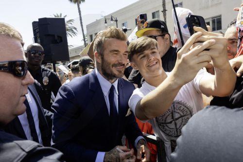 epa13033497 British former soccer player David Beckham signs autographs with fans during a ceremony honoring him with a star on the Hollywood Walk of Fame in Los Angeles, California, USA, 12 June 2026. Beckham was recognized in the Sports Entertainment category.  EPA/TED SOQUI