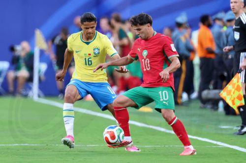 epa13035663 Douglas Santos of Brazil (L) in action against Brahim Diaz of Morocco (R) during the FIFA World Cup 2026 group stage match Brazil against Morocco, in East Rutherford, New Jersey, USA, 13 June 2026.  EPA/OLGA FEDOROVA