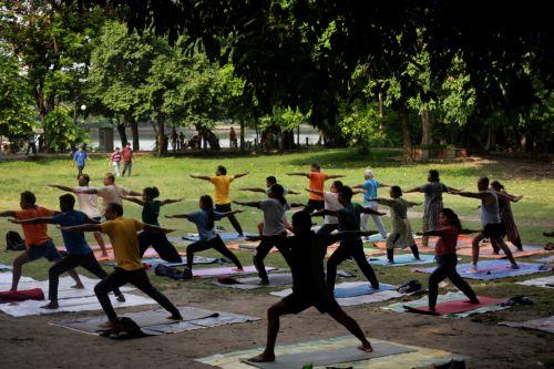 epa13040436 People attend a mass yoga session ahead of the 12th International Yoga Day in Kolkata, India, 16 June 2026. The 'International Day of Yoga' is celebrated annually on 21 June and has been recognized worldwide since 2015. The United Nations declared yoga a practice of physical, mental, and spiritual exercise originating in ancient India. This...