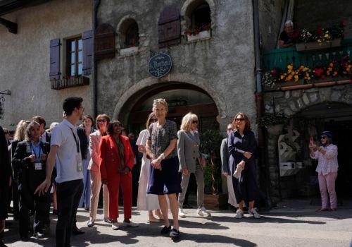 epa13040965 (L-R) Germany's Charlotte Merz, Kenia's Rachel Kimetto, Canada's Diana Fox Carney, France's Brigitte Macron, and Brazil's Janja Lula da Silva listen to a guide during a spouses program on the sidelines of the G7 summit in Yvoire, France, 16 June 2026. The 52nd G7 Summit takes place in Evian-les-Bains from 15 to 17 June 2026.  EPA/Christophe Ena...