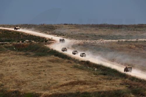 epa13044297 Military vehicles move within southern Lebanon, as seen from the Israeli side of the border in the Upper Galilee, northern Israel, 17 June 2026. An Israeli army spokesperson reported that a soldier was severely injured, two soldiers were moderately injured, and two additional soldiers were lightly injured as a result of an explosive drone impact...