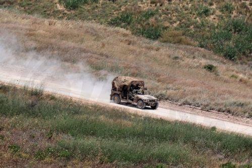 epa13044298 A military vehicles moves within southern Lebanon, as seen from the Israeli side of the border in the Upper Galilee, northern Israel, 17 June 2026. An Israeli army spokesperson reported that a soldier was severely injured, two soldiers were moderately injured, and two additional soldiers were lightly injured as a result of an explosive drone...