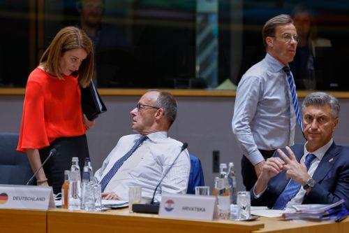 epa13047718 European Parliament President Roberta Metsola (L) talks to Germany's Chancellor Friedrich Merz as they wait for Ukraine's President Volodymyr Zelenskyy to join a round table meeting at the European Council summit in Brussels, Belgium, 18 June 2026.  EPA/GEERT VANDEN WIJNGAERT / POOL