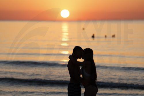 epa13060123 A couple kisses at sunrise at Malvarrosa Beach after the Night of San Juan celebrations in Valencia, Spain, 24 June 2026. To welcome the summer solstice, Spain comes alive during the Night of San Juan from 23 to 24 June. The celebration features bonfires on beaches and town squares, culminating at midnight when crowds rush into the Mediterranean...