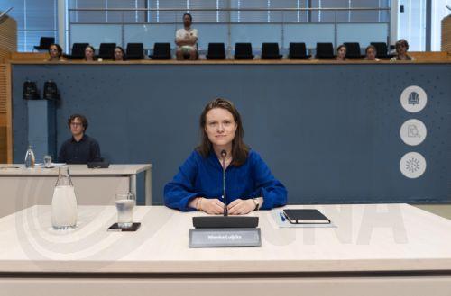 epa13066420 Former National Action Committee for Students (LAKS) chair Nienke Luijckx (C) attends a public hearing of the parliamentary inquiry committee into the COVID-19 pandemic policy, in The Hague, the Netherlands, 26 June 2026.  EPA/JEROEN JUMELET