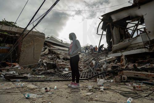 epa13070219 A woman waits in front of a building damaged by an earthquake in La Guaira, Venezuela, 27 June 2026.  EPA/Henry Chirinos