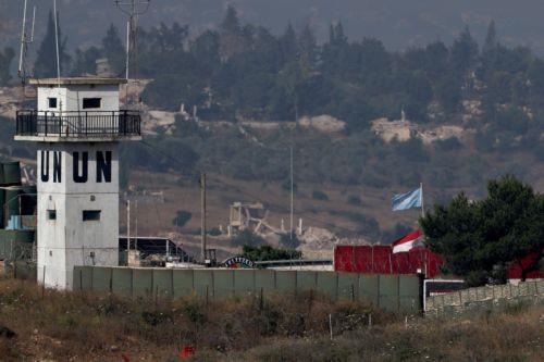 epa13070683 UN and Lebanese flags fly at a United Nations Interim Force in Lebanon (UNIFIL) base in southern Lebanon, as seen from the Israeli side of the border in the Upper Galilee, northern Israel, 28 June 2026, amid an Israel-Lebanon ceasefire.  EPA/ATEF SAFADI