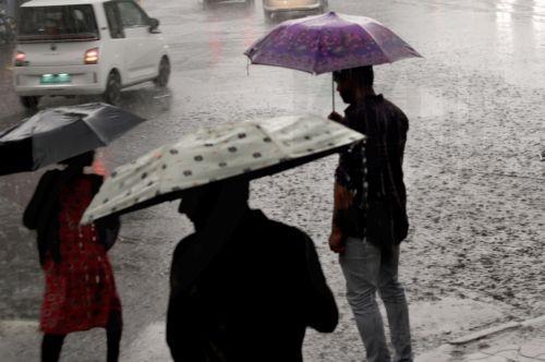 epa13072417 People make their way through a water logged street during heavy rain in Kolkata, India 29 June 2026. The India Meteorological Department (IMD) issued a red alert for thunderstorms with lightning and heavy rainfall, disrupting daily life across parts of West Bengal for the past several days.  EPA/PIYAL ADHIKARY