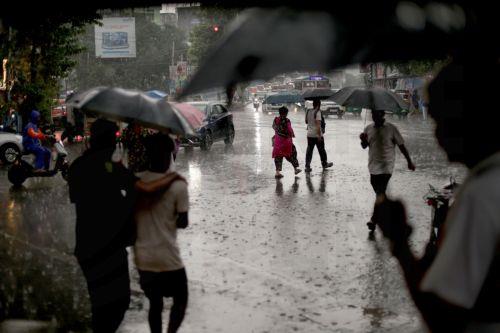 epa13072418 People make their way through a water logged street during heavy rain in Kolkata, India 29 June 2026. The India Meteorological Department (IMD) issued a red alert for thunderstorms with lightning and heavy rainfall, disrupting daily life across parts of West Bengal for the past several days.  EPA/PIYAL ADHIKARY