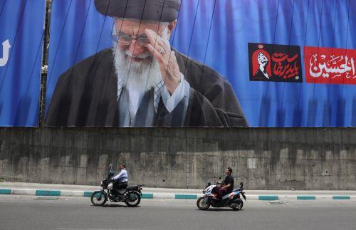 epa13077399 Iranians ride motorbikes past a large-scale poster of late Iranian Supreme Leader Ayatollah Ali Khamenei displayed along a highway, in Tehran, Iran, 01 July 2026. Iran is set to hold a multi-day state funeral from 04 to 09 July 2026 for late Iranian Supreme Leader Ayatollah Ali Khamenei, who was assassinated on 28 February.  EPA/ABEDIN...