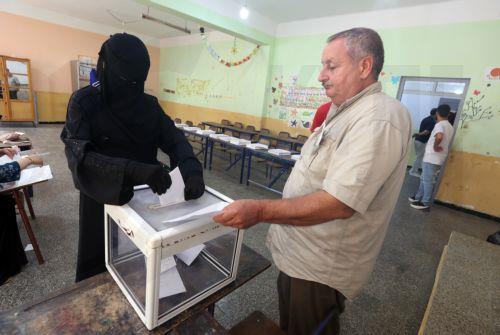 epa13079878 An Algerian woman casts her ballot at a polling station during parliamentary elections in Algiers, Algeria, 02 July 2026. The electorate, including diaspora voters, comprises 24,727,041 registered voters. The elections will elect the 407 members of the tenth legislature of the National People’s Assembly (APN), who will serve five-year terms. ...