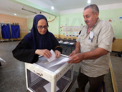 epa13079879 An Algerian woman casts her ballot at a polling station during parliamentary elections in Algiers, Algeria, 02 July 2026. The electorate, including diaspora voters, comprises 24,727,041 registered voters. The elections will elect the 407 members of the tenth legislature of the National People’s Assembly (APN), who will serve five-year terms. ...