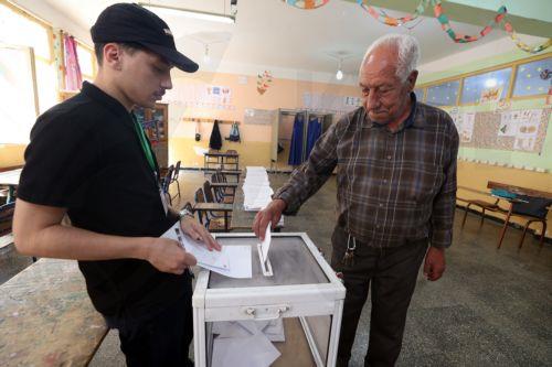 epa13079881 An Algerian man casts her ballot at a polling station during parliamentary elections in Algiers, Algeria, 02 July 2026. The electorate, including diaspora voters, comprises 24,727,041 registered voters. The elections will elect the 407 members of the tenth legislature of the National People’s Assembly (APN), who will serve five-year terms. ...