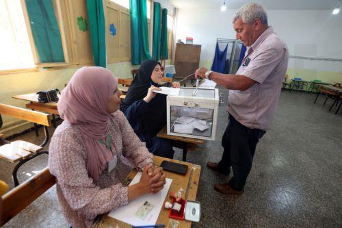 epa13079882 An Algerian man casts her ballot at a polling station during parliamentary elections in Algiers, Algeria, 02 July 2026. The electorate, including diaspora voters, comprises 24,727,041 registered voters. The elections will elect the 407 members of the tenth legislature of the National People’s Assembly (APN), who will serve five-year terms. ...