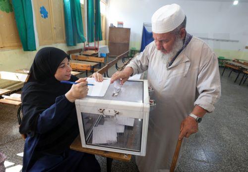 epa13079883 An Algerian man casts her ballot at a polling station during parliamentary elections in Algiers, Algeria, 02 July 2026. The electorate, including diaspora voters, comprises 24,727,041 registered voters. The elections will elect the 407 members of the tenth legislature of the National People’s Assembly (APN), who will serve five-year terms. ...