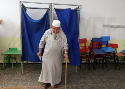 epa13079885 An Algerian man emerges from a polling booth before casting his vote at a polling station during parliamentary elections in Algiers, Algeria, 02 July 2026. The electorate, including diaspora voters, comprises 24,727,041 registered voters. The elections will elect the 407 members of the tenth legislature of the National People’s Assembly (APN),...