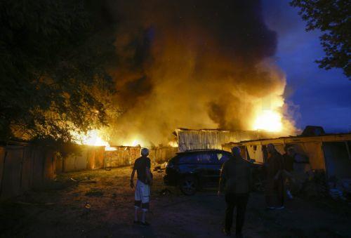 epa13090511 Local residents battle a fire during a large-scale combined Russian attack on a residential area in Kyiv, Ukraine, 06 July 2026, amid the Russian invasion. At least 10 people were killed and more than 43 injured after the overnight attack on Kyiv, according to the State Emergency Service. Russia launched 351 drones and 68 missiles of various...