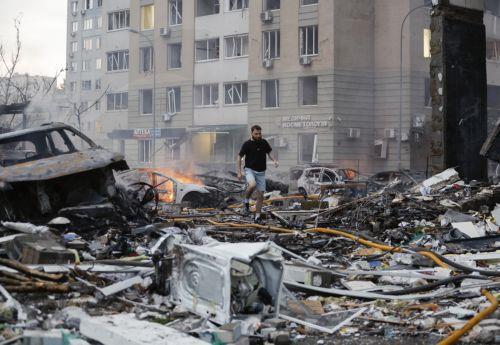 epa13090521 Local people react at the site of Russian strike on a residential building during a large-scale combined attack on a residential area in Kyiv, Ukraine, 06 July 2026, amid the Russian invasion. At least 10 people were killed and more than 43 injured after the overnight attack on Kyiv, according to the State Emergency Service. Russia launched 351...