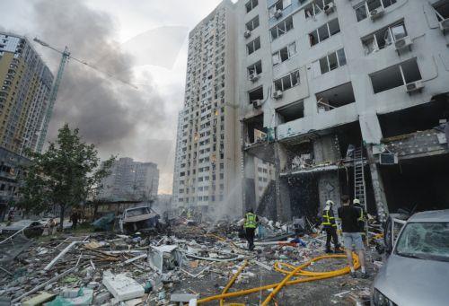 epa13090524 Ukrainian rescuers work at the site of a Russian missile strike on a residential area in Kyiv, Ukraine, 06 July 2026, amid the Russian invasion. At least 10 people were killed and more than 43 injured after the overnight attack on Kyiv, according to the State Emergency Service. Russia launched 351 drones and 68 missiles of various types during...