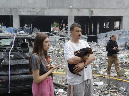 epa13090529 Local people react at the site of Russian strike on a residential building during a large-scale combined attack on a residential area in Kyiv, Ukraine, 06 July 2026, amid the Russian invasion. At least 10 people were killed and more than 43 injured after the overnight attack on Kyiv, according to the State Emergency Service. Russia launched 351...