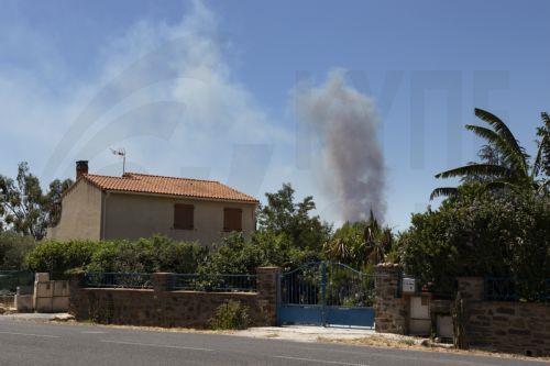 epa13091784 ​Smoke rises from a wildfire burning in Ille-sur-Tet, southern France, 06 July 2026. The fire has scorched some 4,600 hectares in the foothills of the French Pyrenees and more thant 10.000 people have been ordered to leave, local ​prefect Pierre Regnault de la Mothe said.  EPA/CHLOE REULET