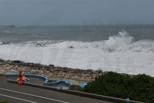 epa13101944 A Taiwanese coast guard personnel patrols at the coastal area as huge waves brought by Typhoon Bavi hit the shore in Hualien city, Taiwan, 10 July 2026. The Central Weather Administration (CWA) issued a land warning at 5:30 a.m. on Friday for Typhoon Bavi. The storm is moving northwest at 25 kilometres per hour and is expected to hit Taiwan...
