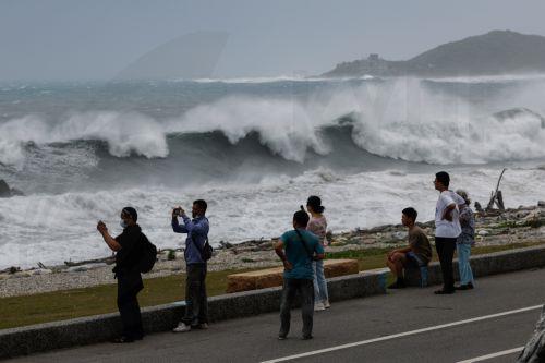 epaselect epa13101942 Residents observe huge waves brought by Typhoon Bavi in Hualien city, Taiwan, 10 July 2026. The Central Weather Administration (CWA) issued a land warning at 5:30 a.m. on Friday for Typhoon Bavi. The storm is moving northwest at 25 kilometres per hour and is expected to hit Taiwan hardest between Friday evening and Saturday. ...